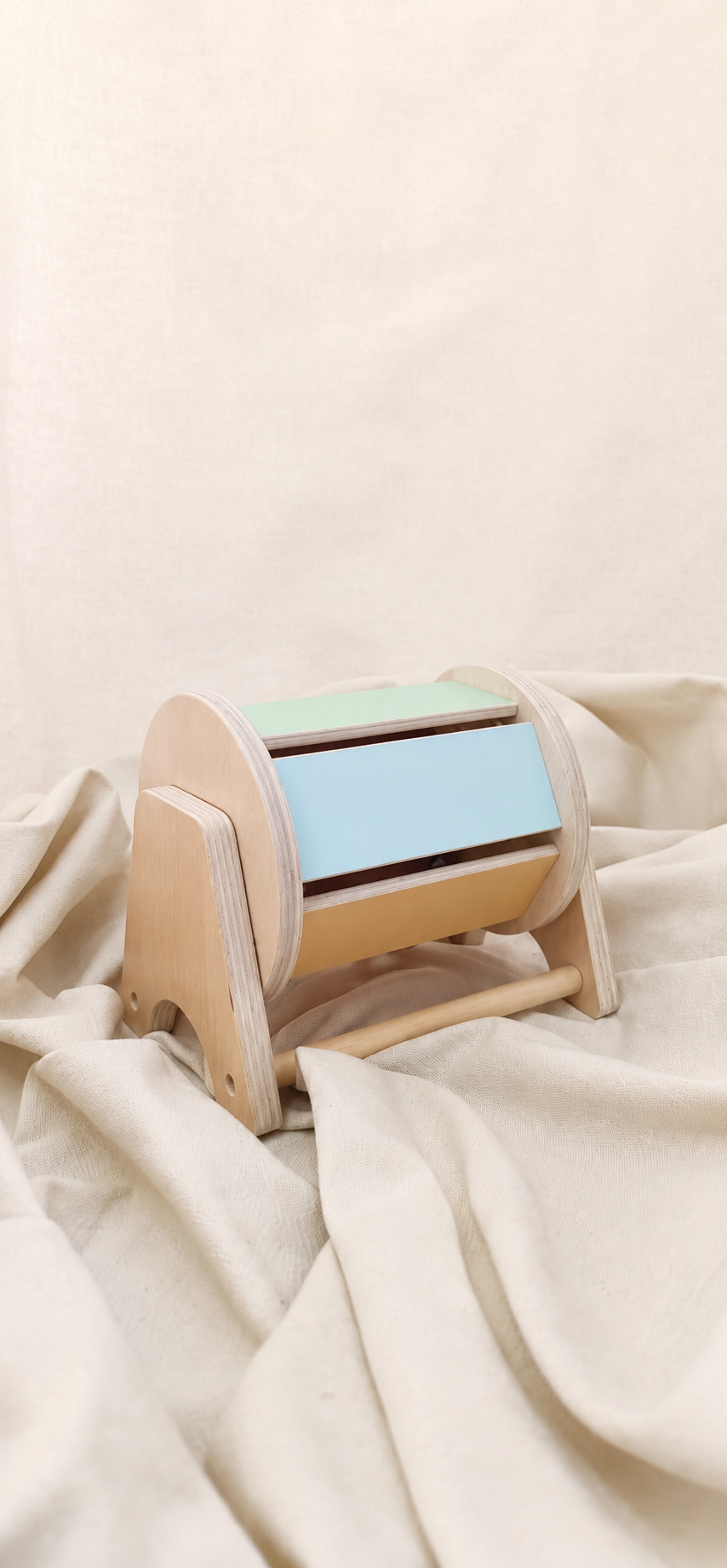 Wooden cylindrical object on a beige fabric background