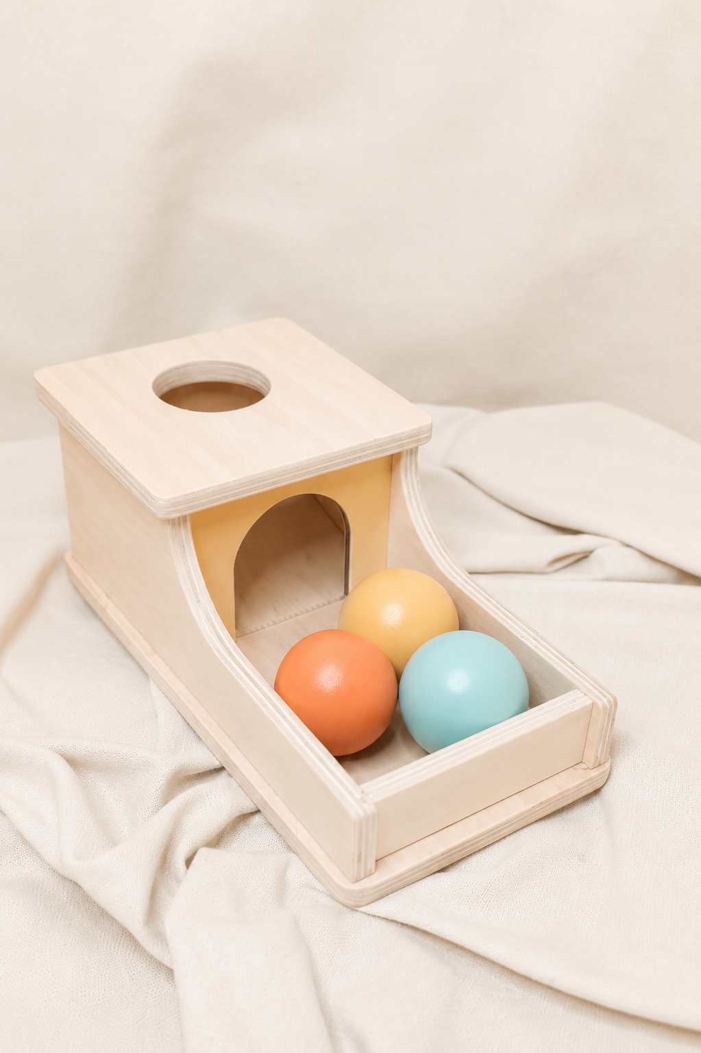 Wooden toy with colorful spheres on a beige background
